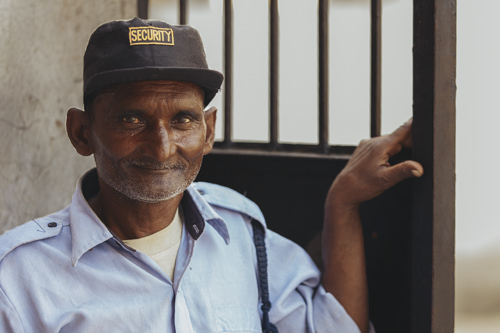 Guard at the gates of a textile factory, Noida, India