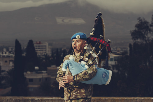 Piper on the roof of Ledra palace, piping in the going down of the sun